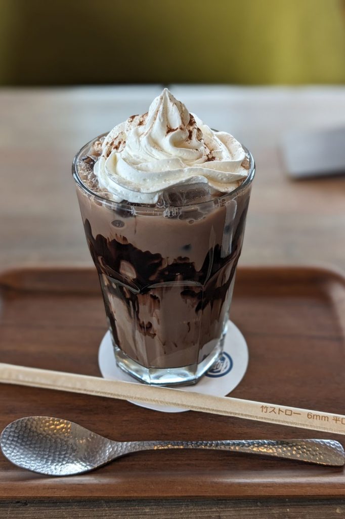 A chocolate and cream with a spoon